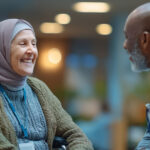 Inclusive healthcare: elderly woman in wheelchair smiling with nurse in clinic lobby