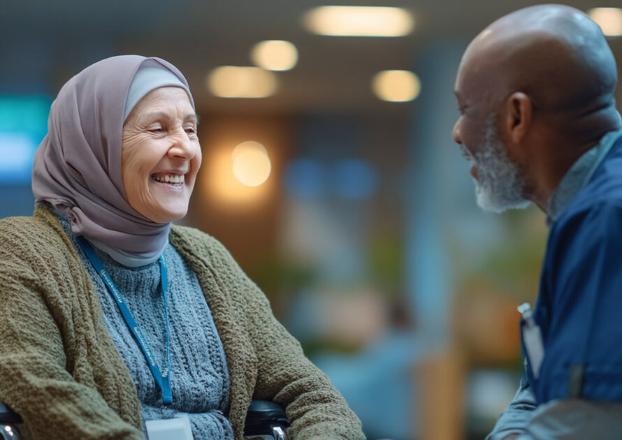 Inclusive healthcare: elderly woman in wheelchair smiling with nurse in clinic lobby