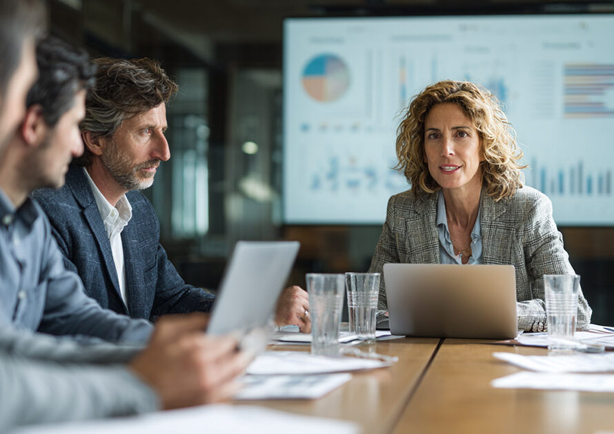 Healthcare leaders discussing hospital revenue cycle optimization strategies in a boardroom