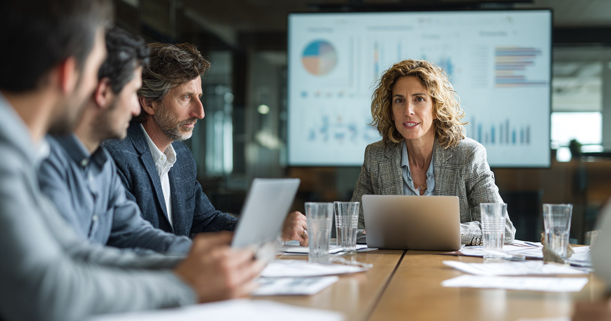 Healthcare leaders discussing hospital revenue cycle optimization strategies in a boardroom