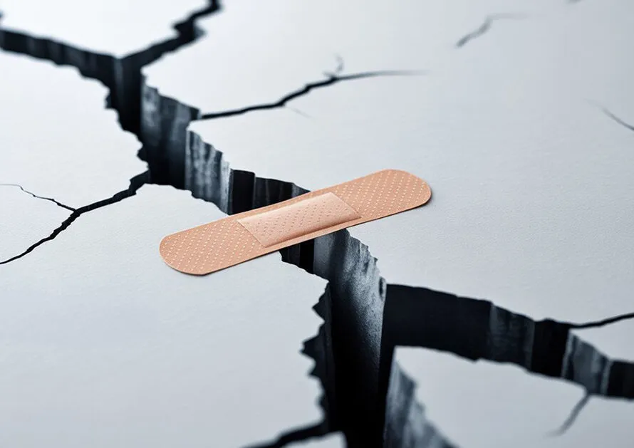 Bandage on crack symbolizing problems with patient assistance programs
